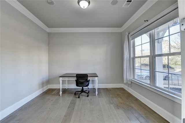 home office featuring visible vents, crown molding, baseboards, and wood finished floors