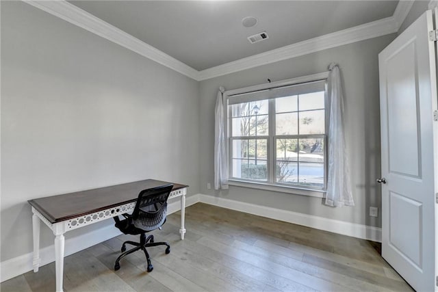 office space featuring baseboards, visible vents, hardwood / wood-style floors, and ornamental molding