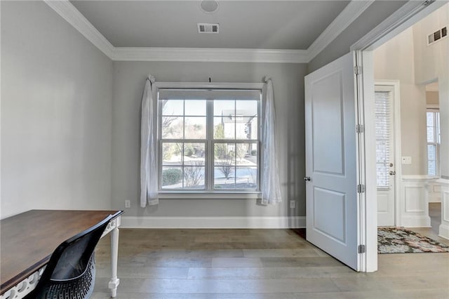 unfurnished office featuring ornamental molding, visible vents, and light wood-style flooring