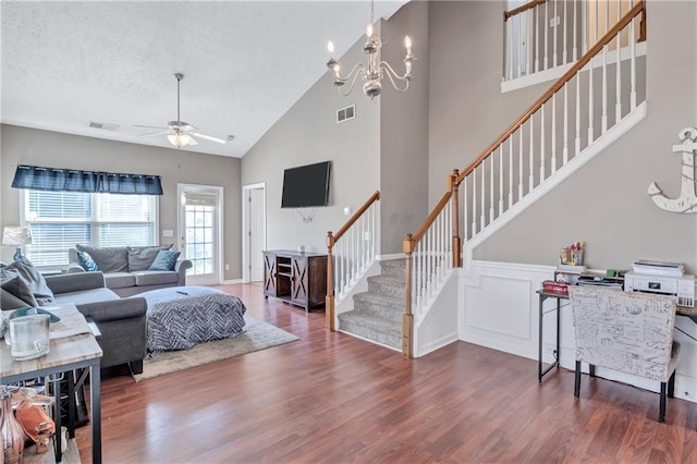 living room featuring ceiling fan with notable chandelier, high vaulted ceiling, and dark hardwood / wood-style floors