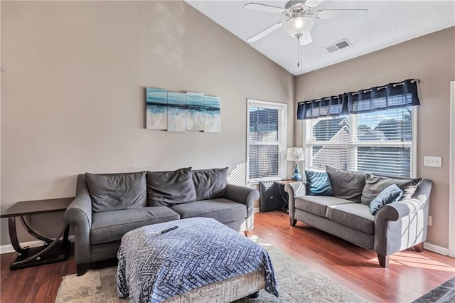 living room featuring ceiling fan, high vaulted ceiling, and wood-type flooring