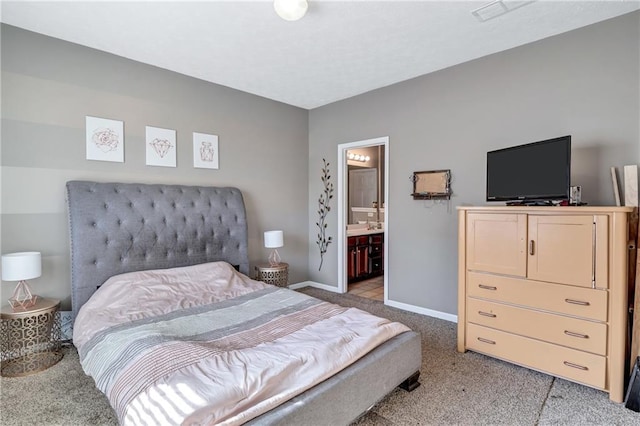 bedroom with light carpet and connected bathroom