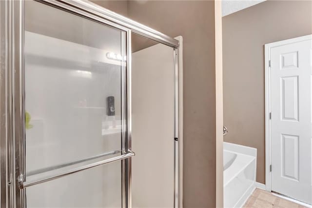 bathroom with separate shower and tub