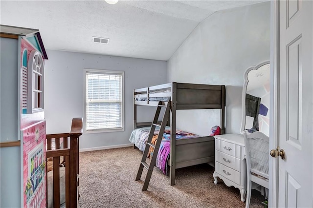 carpeted bedroom featuring a textured ceiling and vaulted ceiling