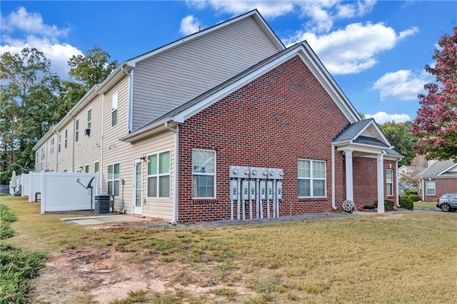 view of home's exterior featuring a yard and central AC