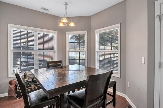 dining room featuring hardwood / wood-style flooring and an inviting chandelier