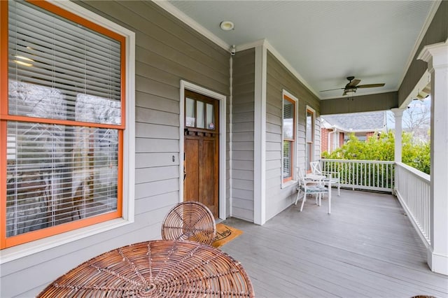 wooden deck featuring a porch and ceiling fan