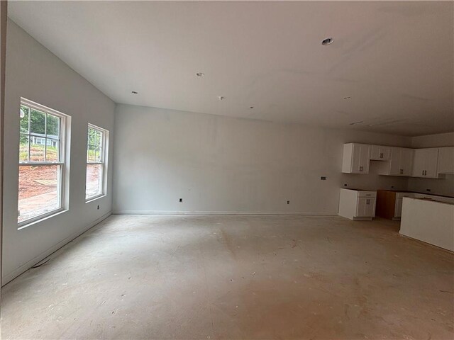 4428 Ryan St, Douglasville, GA 30135 - unfurnished living room featuring concrete flooring and baseboards