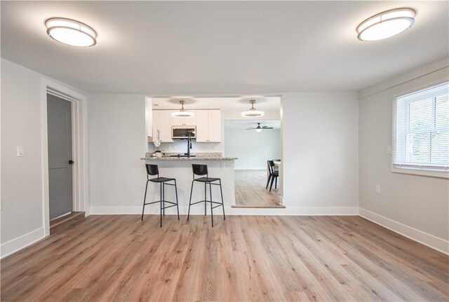 empty room with an AC wall unit, dark wood finished floors, and baseboards