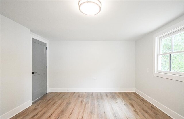 bathroom featuring toilet, wood finished floors, vanity, and baseboards