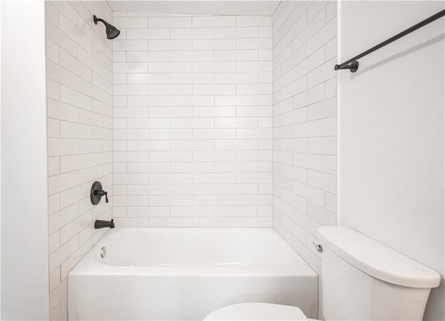 bathroom featuring toilet and tiled shower / bath