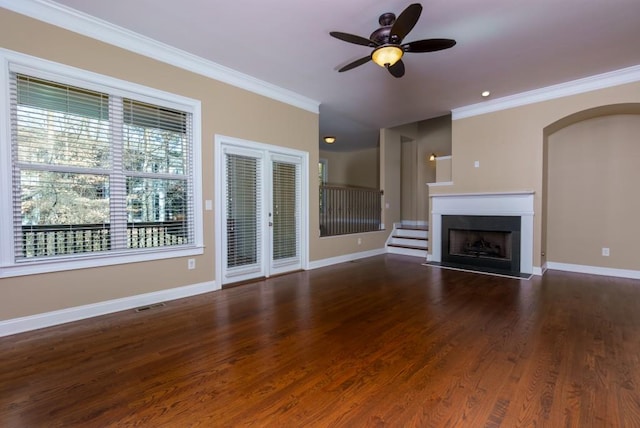 unfurnished living room featuring ornamental molding, dark wood-type flooring, and ceiling fan