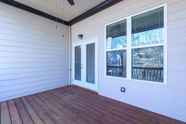 wooden terrace featuring french doors and ceiling fan