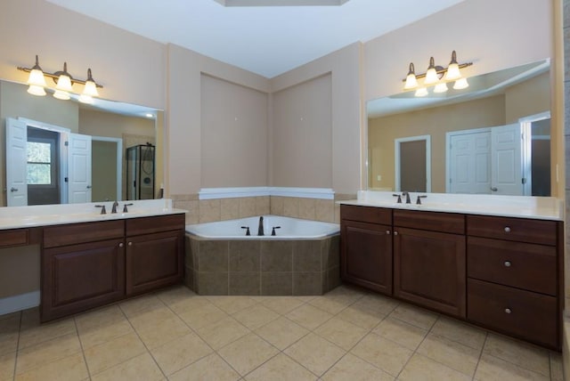 bathroom with vanity, tile patterned flooring, and shower with separate bathtub