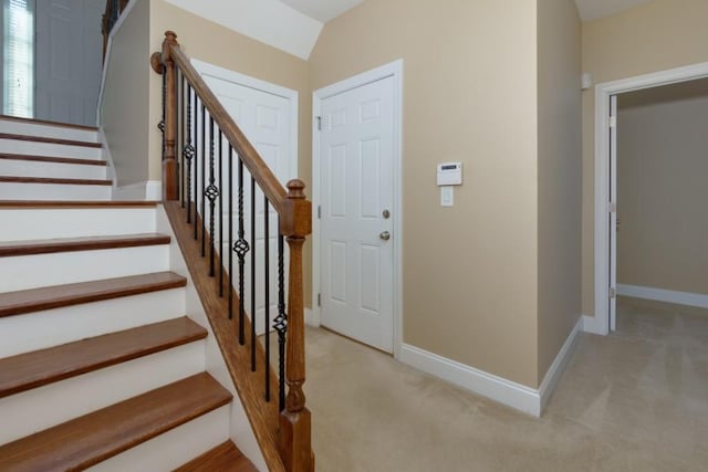 interior space with lofted ceiling and carpet floors