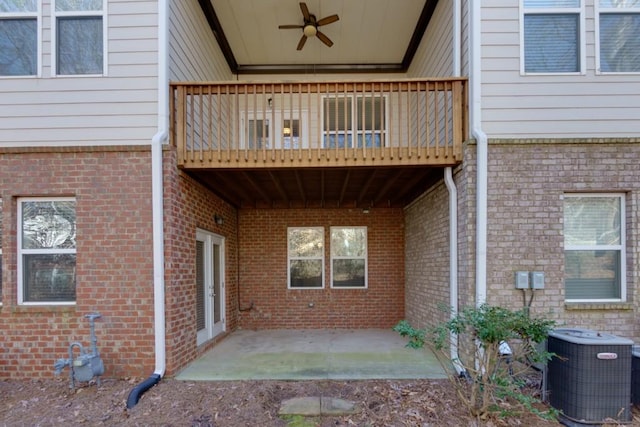 doorway to property featuring a balcony, cooling unit, ceiling fan, and a patio area