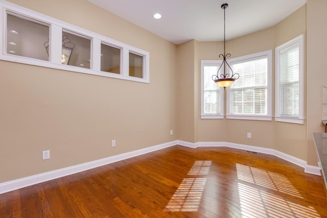 unfurnished dining area with hardwood / wood-style flooring