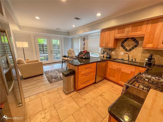 kitchen featuring kitchen peninsula, stainless steel dishwasher, french doors, sink, and tasteful backsplash