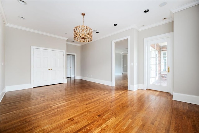 3657 Peachtree Rd NE Unit 4A, Atlanta, GA 30319 - spare room with a chandelier, light wood-style flooring, and crown molding