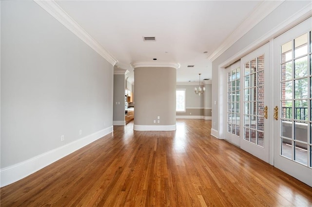 3657 Peachtree Rd NE Unit 4A, Atlanta, GA 30319 - spare room featuring ornamental molding, a chandelier, wood finished floors, and healthy amount of natural light