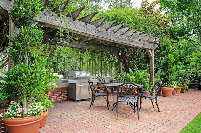 3657 Peachtree Rd NE Unit 4A, Atlanta, GA 30319 - view of patio featuring an outdoor kitchen, a pergola, and outdoor dining space