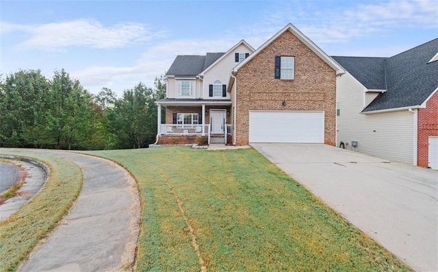 view of front of house with a porch, a garage, and a front lawn