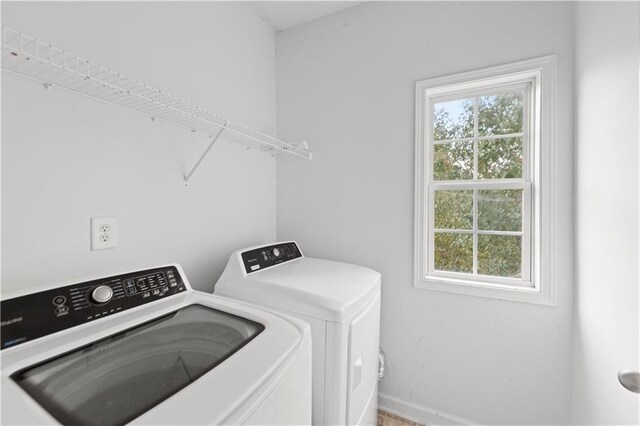 clothes washing area with separate washer and dryer