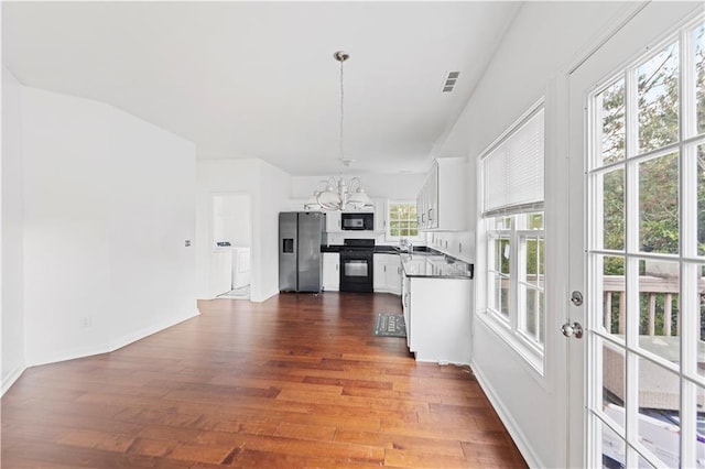 kitchen with dark hardwood / wood-style flooring, black appliances, pendant lighting, an inviting chandelier, and white cabinetry