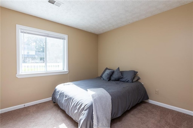 carpeted bedroom featuring a textured ceiling