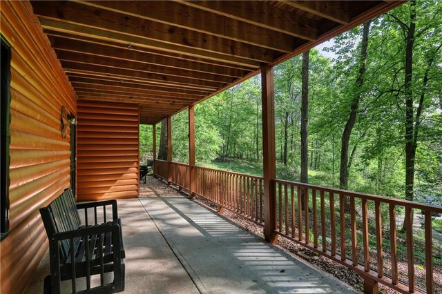 wooden deck featuring a forest view