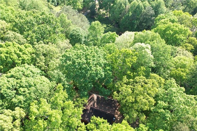 drone / aerial view featuring a wooded view