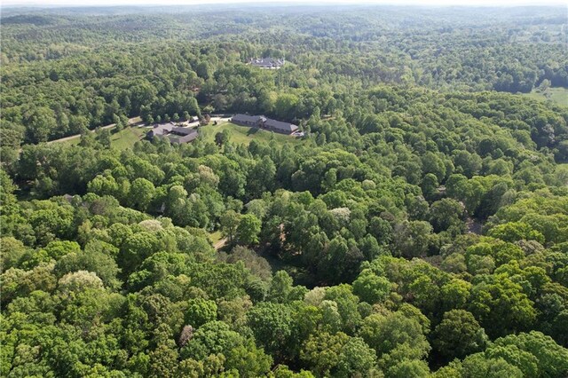 birds eye view of property with a forest view