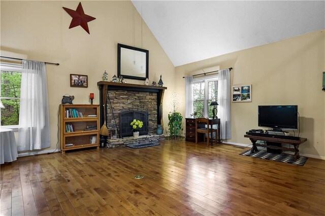 living area featuring high vaulted ceiling, baseboards, a fireplace, and hardwood / wood-style floors