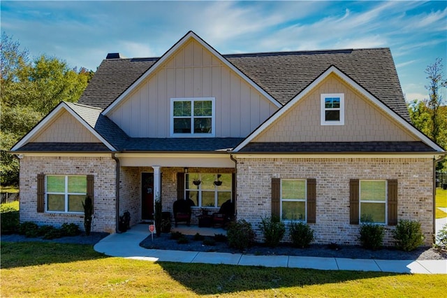 craftsman-style house featuring a front yard and covered porch