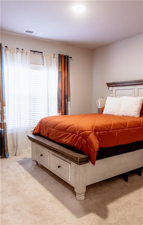 bedroom featuring light colored carpet