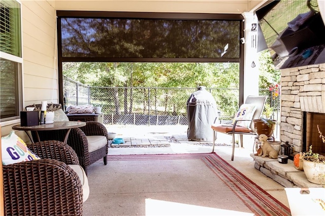 view of patio featuring an outdoor stone fireplace