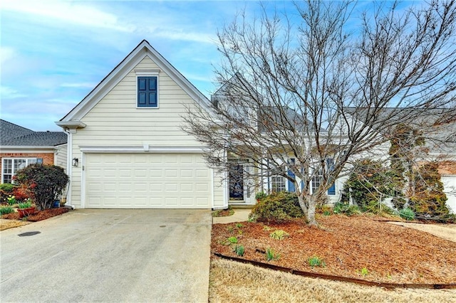 view of front of house with a garage and concrete driveway