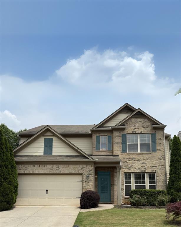 4965 Brierstone Dr, Alpharetta, GA 30004 - view of front of home with concrete driveway, a front yard, and brick siding