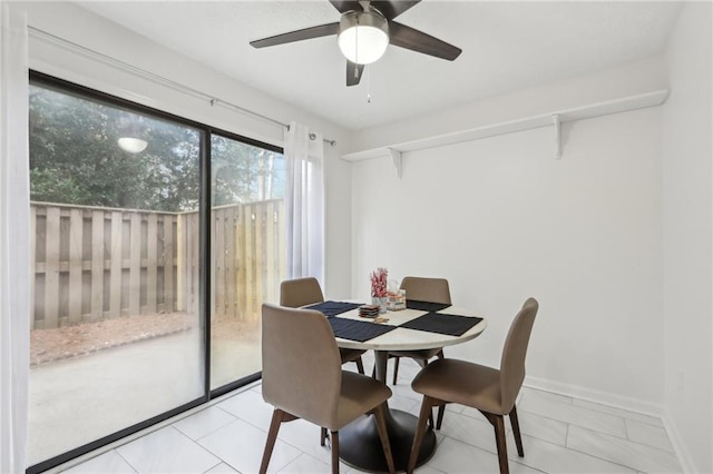 tiled dining area with ceiling fan