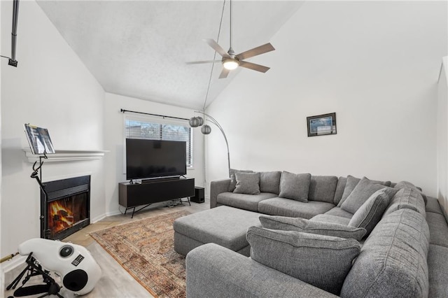 living room featuring high vaulted ceiling and ceiling fan