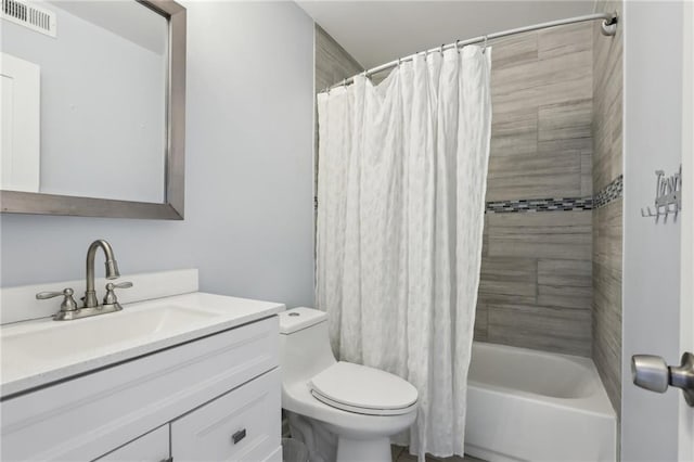 full bathroom with vanity, shower / tub combo with curtain, and toilet