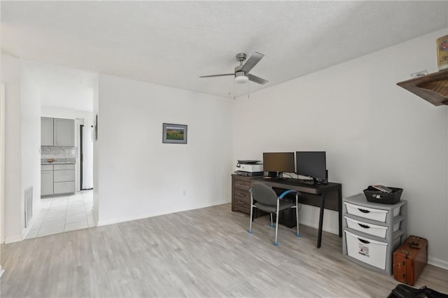 office space with light hardwood / wood-style flooring and ceiling fan