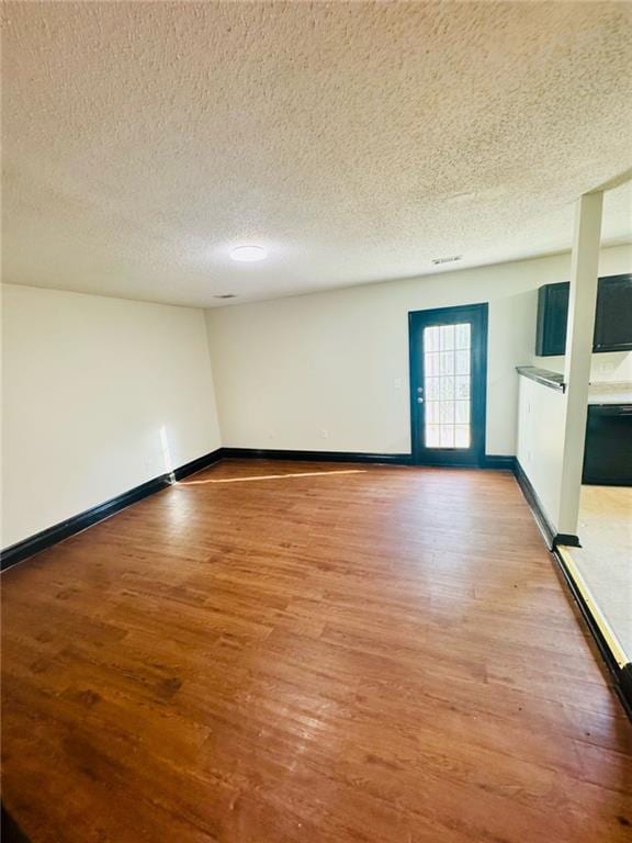 225 Colser Dr, Covington, GA 30016 - unfurnished room with light wood finished floors, a textured ceiling, and baseboards