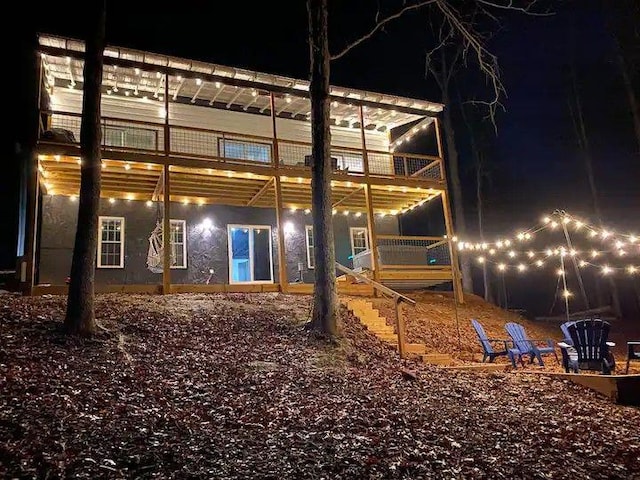 view of back house at twilight