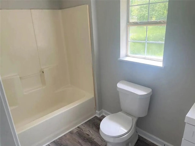 full bathroom with hardwood / wood-style floors, vanity, bathtub / shower combination, and toilet