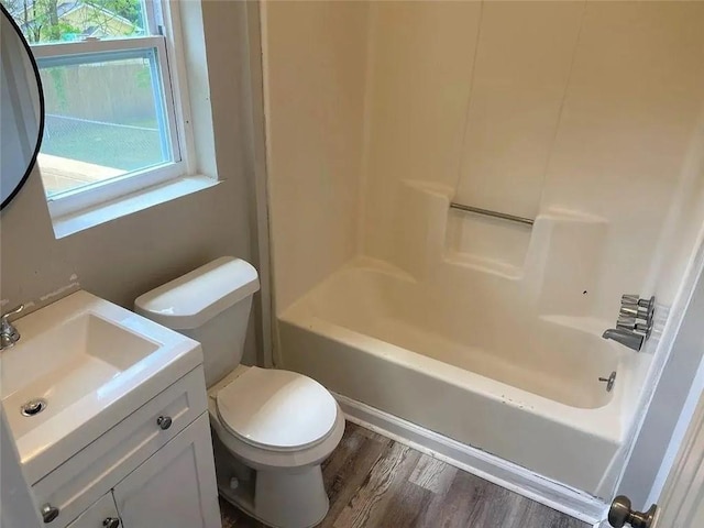 full bathroom featuring toilet, vanity, shower / bath combination, and hardwood / wood-style flooring