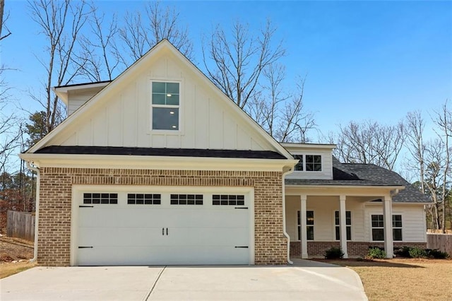 view of front of property with concrete driveway, brick siding, and an attached garage