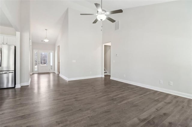 unfurnished living room with stairway, dark wood-style flooring, visible vents, and baseboards