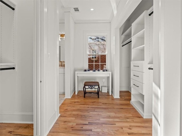 walk in closet with light wood-type flooring and visible vents