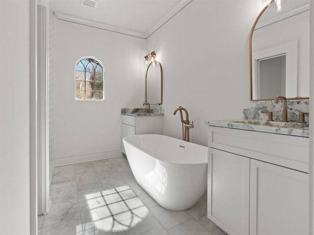 bathroom with marble finish floor, ornamental molding, a soaking tub, and two vanities